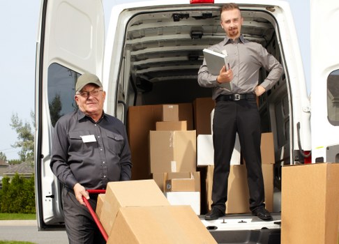 Removal team managing moving day logistics in a West London street
