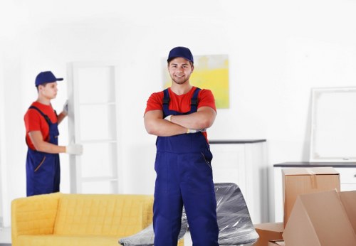 Professional movers handling boxes and furniture in an Earls Court property
