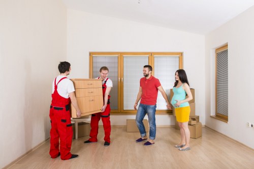 A local moving team handling furniture and packed boxes in Earls Court