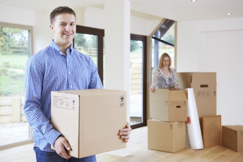 Professional movers handling stairs in a typical Earls Court apartment building