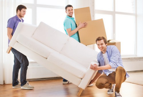 Moving crew navigating stairs in an Earls Court apartment building