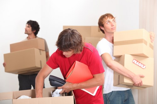 Office relocation team preparing equipment for loading
