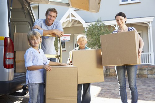 Packed moving boxes and furniture prepared for removals in a London flat