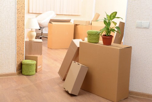 Packed boxes and furniture ready for same day removals in a London flat