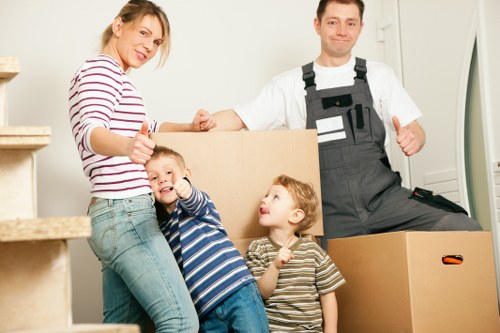 Careful furniture handling during a move in a busy Earls Court street